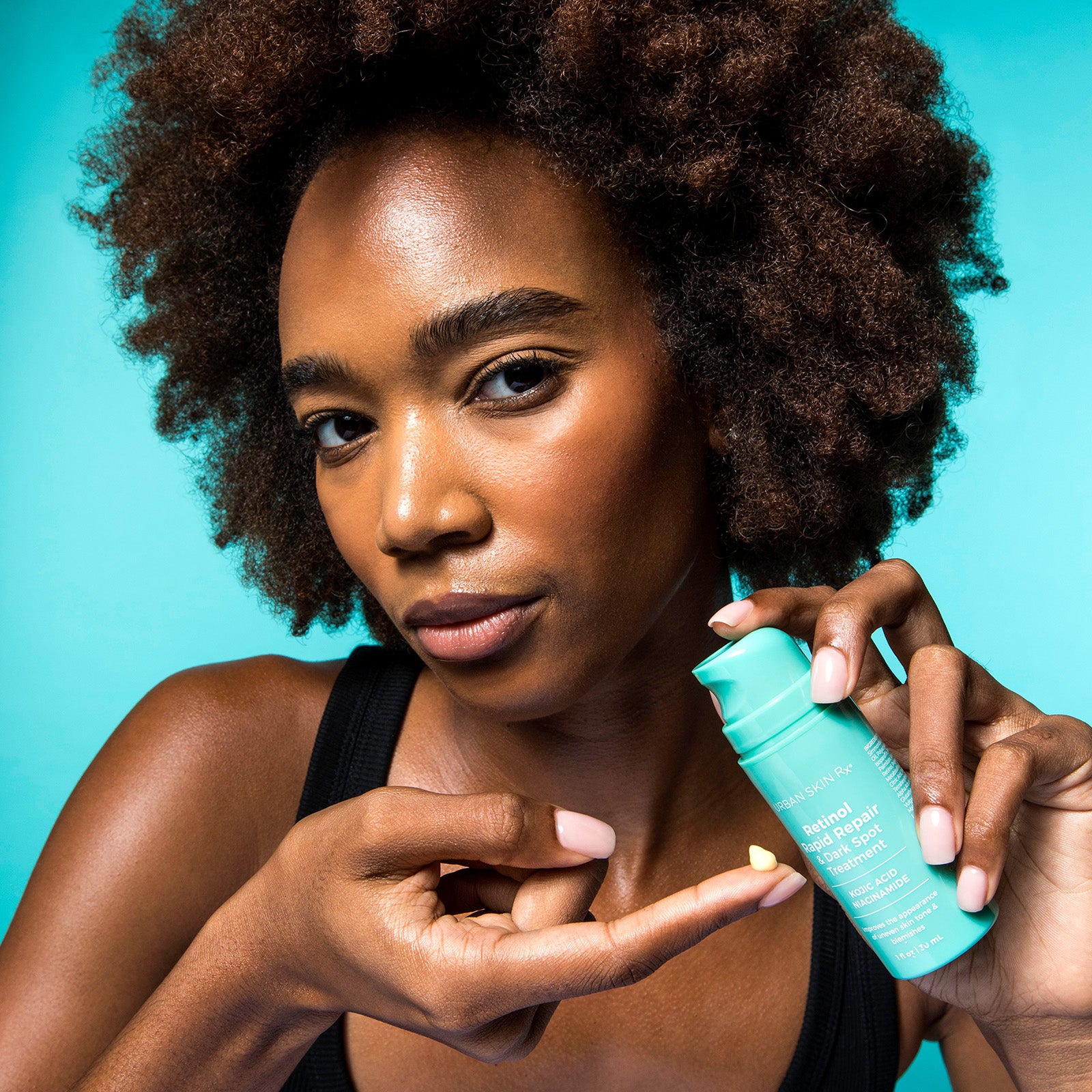 Woman applying USRx Retinol Rapid Repair to her face