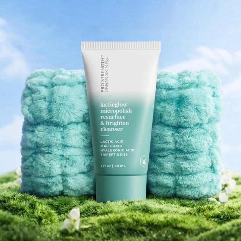 Bottle of USRx LacticGlow Cleanser and wrist cuffs on a light blue background