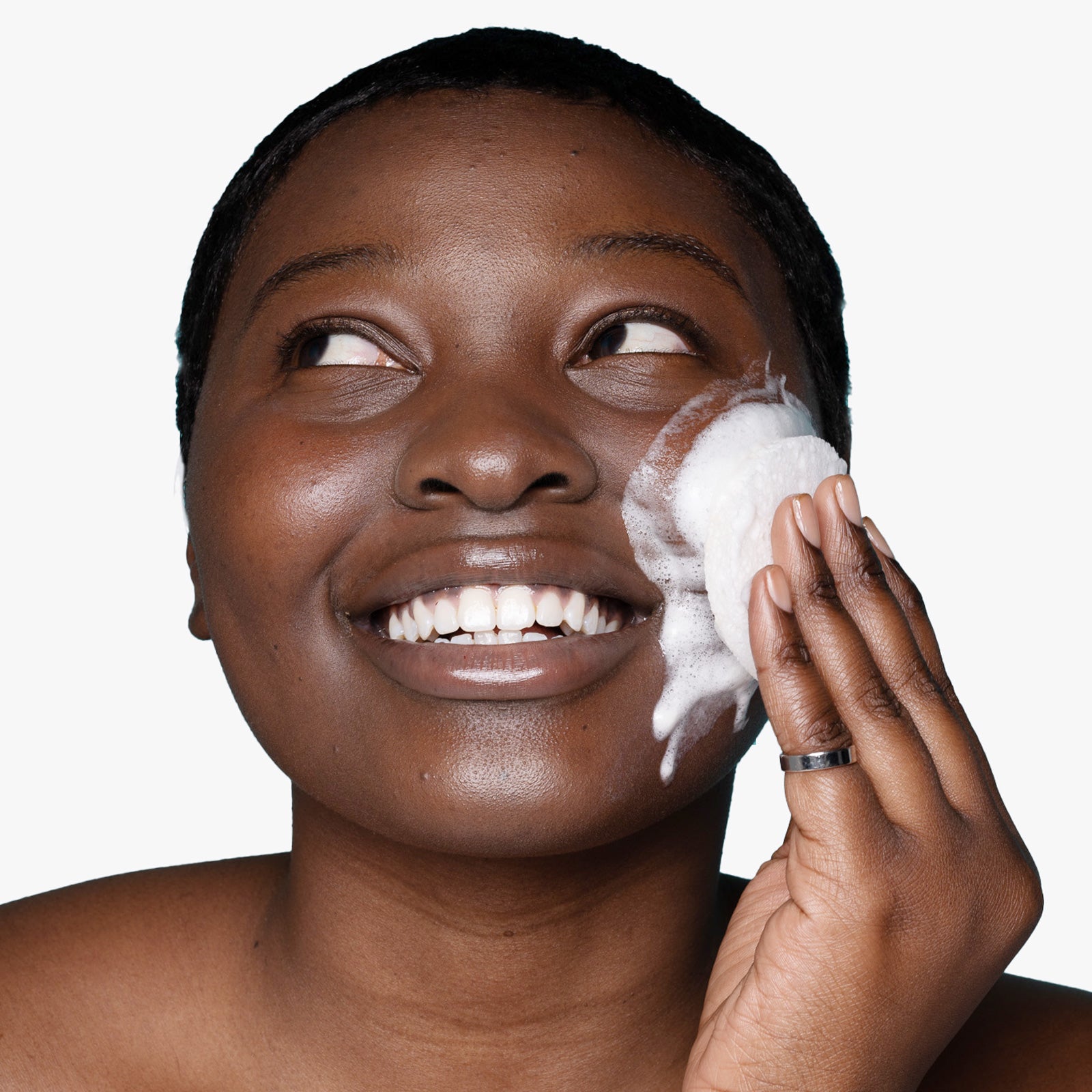Woman applying USRx clear skin cleansing bar suds to her face