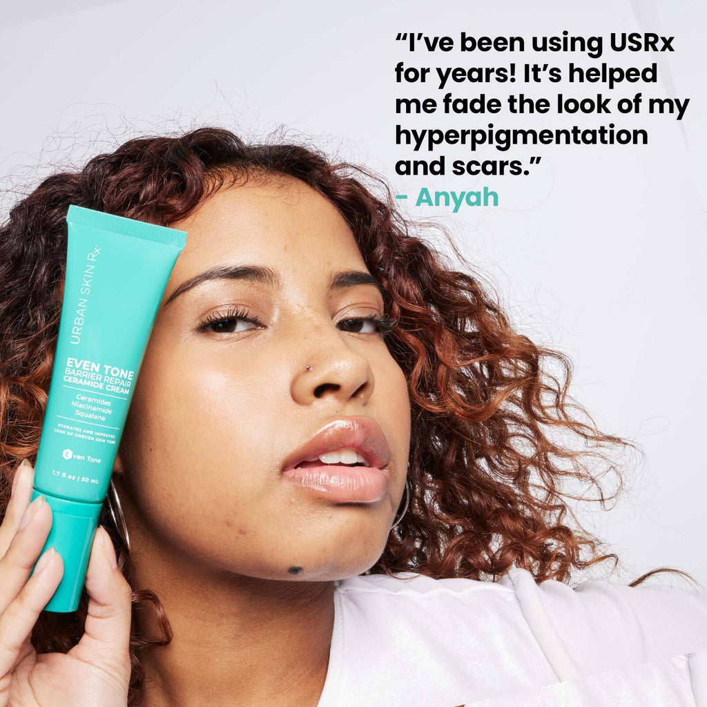 Woman holding bottle of Urban Skin RX Even Tone Barrier Repair Ceramide Cream next to her face