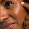 Woman applying Urban Skin RX Hydrafirm Brightening Serum to her face