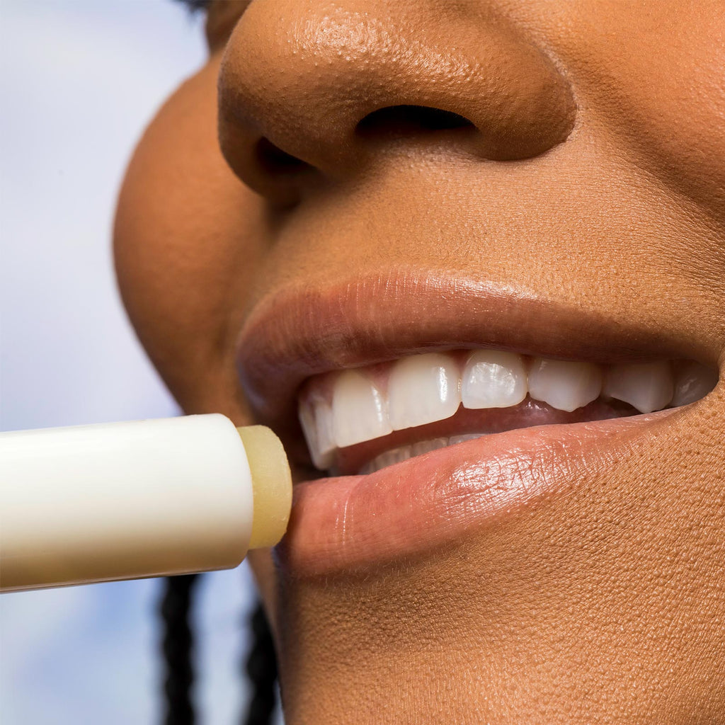 Woman applying Urban Skin RX Cool Mint Sunscreen Lip Balm to her lips