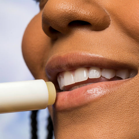 Woman applying Urban Skin RX Sunscreen Lip Balm to her lips
