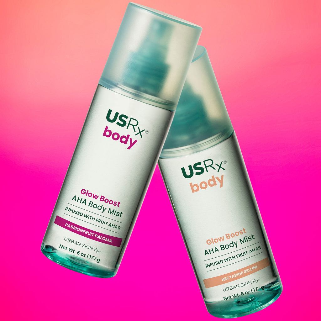 Bottles of USRX Glow Boost AHA Body Mists in Passionfruit Paloma and Nectarine Bellini on a pink background