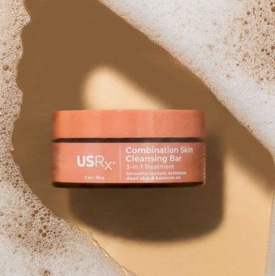 Jar of USRx Combination Skin Cleansing Bar surrounded by suds