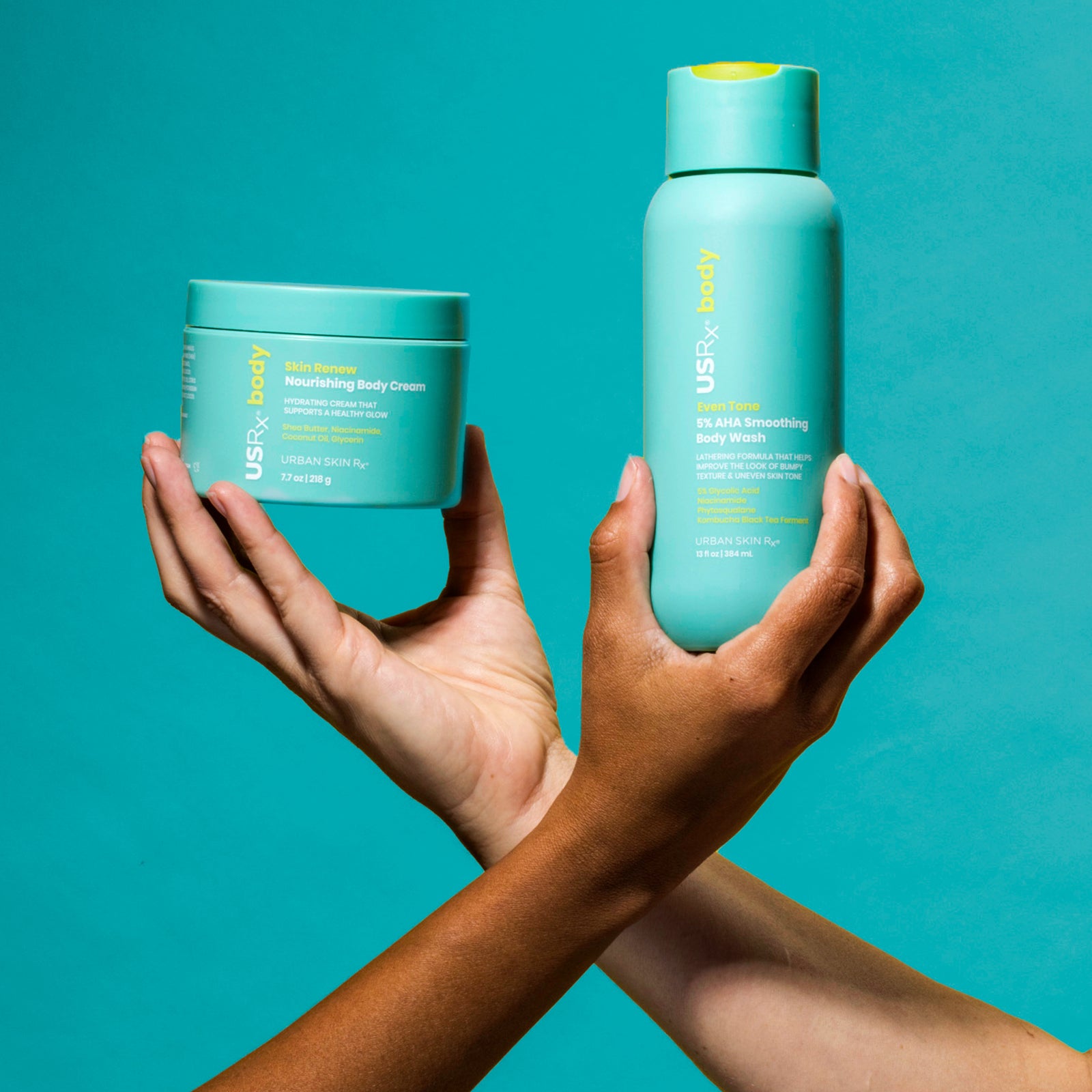 Bottle of USRx Even Tone 5% AHA Smoothing Body Wash and jar of Skin Renew Nourishing Body Cream on a light blue background