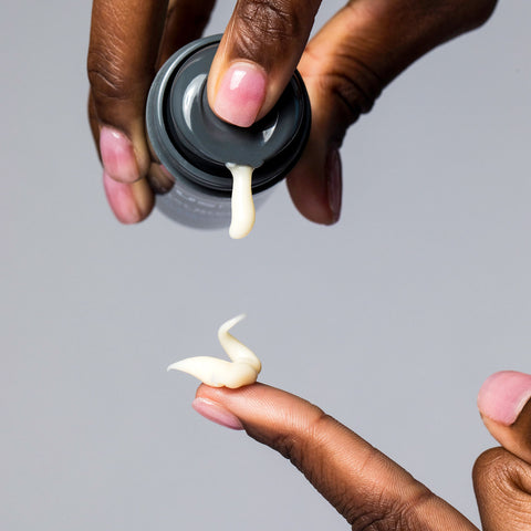 Woman dispensing USRx After Breakout serum on to her finger