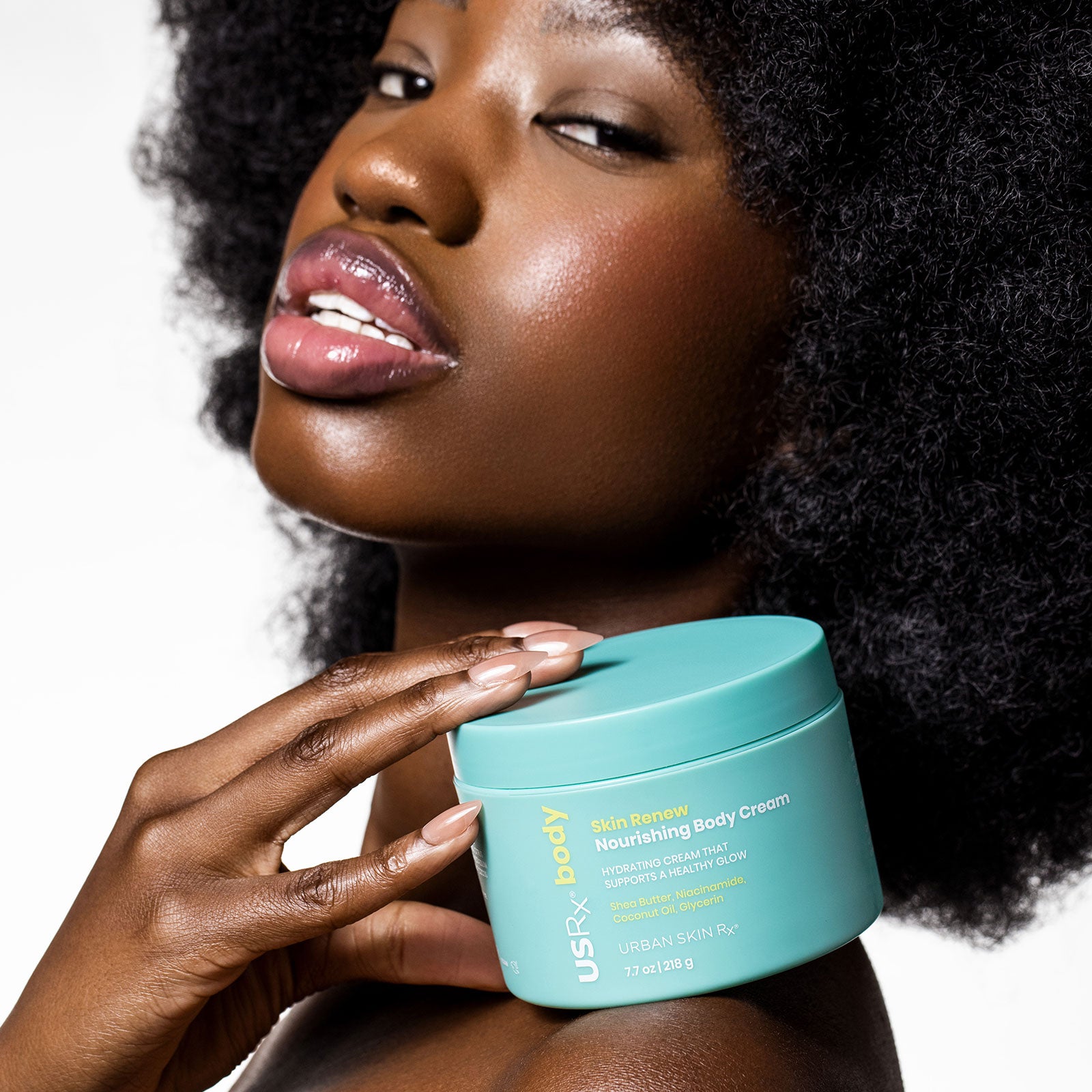 Woman holding a jar of USRx Skin Renew Nourishing Body Cream 