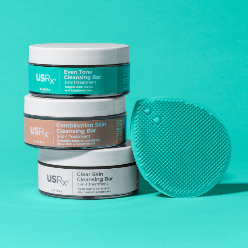 USRx cleansing bars with a green scrubber on a teal background