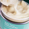 Open jar of USRx even tone cleanser with lathery suds