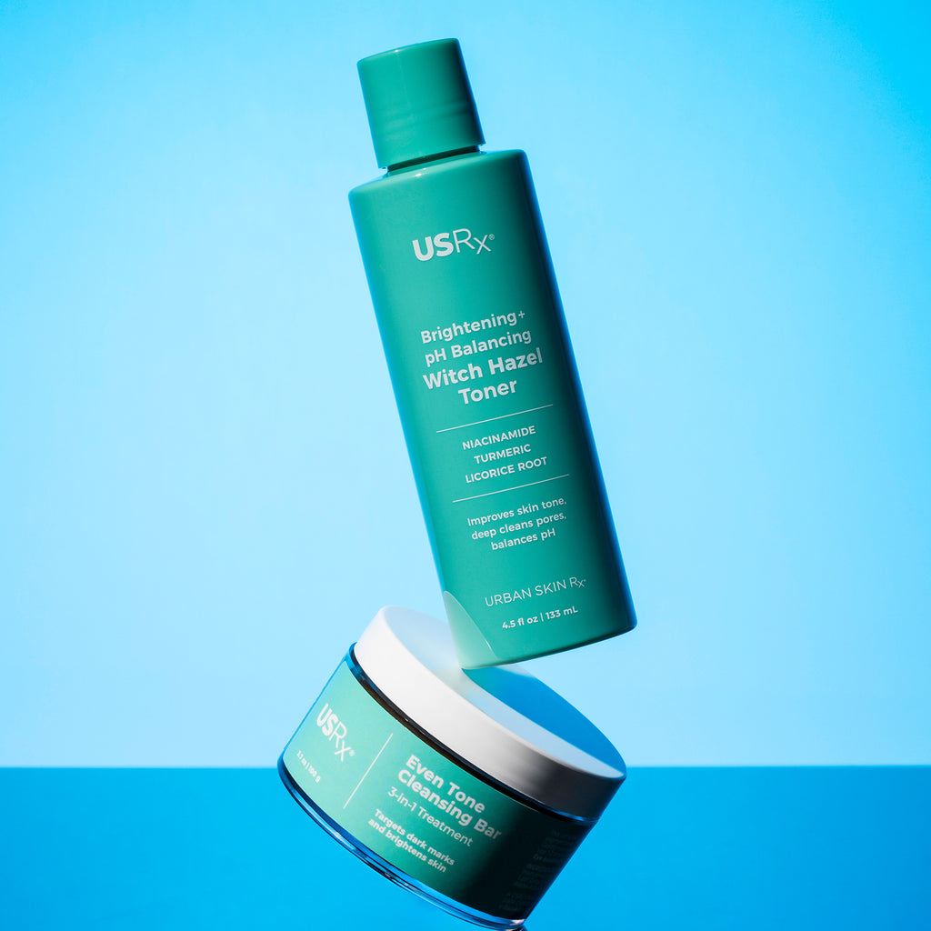 Bottles of USRx witch hazel toner and even tone cleansing bar on a blue background