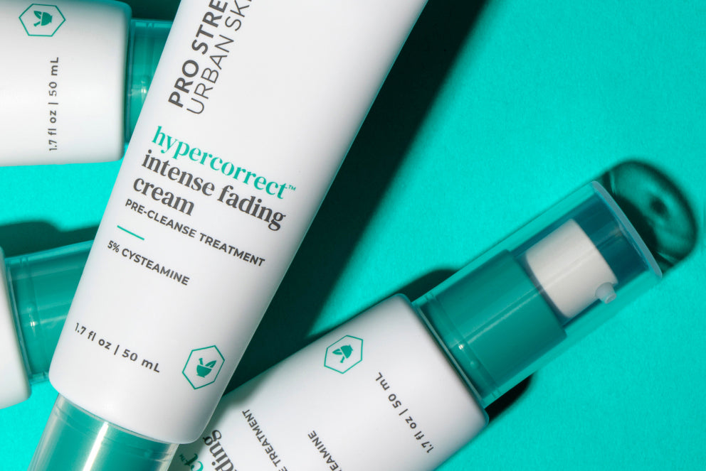Bottles of USRx Hypercorrect Intense Fading Cream on a light blue background