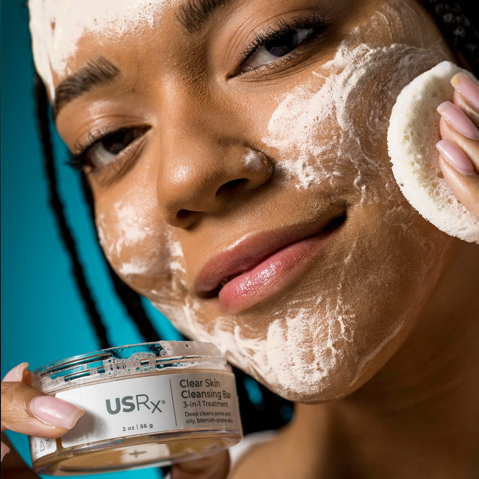 Woman applying USRx Clear Skin Cleansing Bar to her face