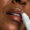 Woman applying Urban Skin RX Hydrating Lip Treatment to her lips