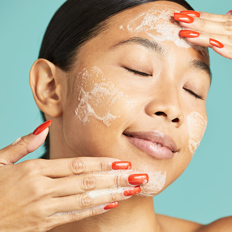 Woman applying Urban Skin RX Even Tone Gentle Gel Cleanser on her face