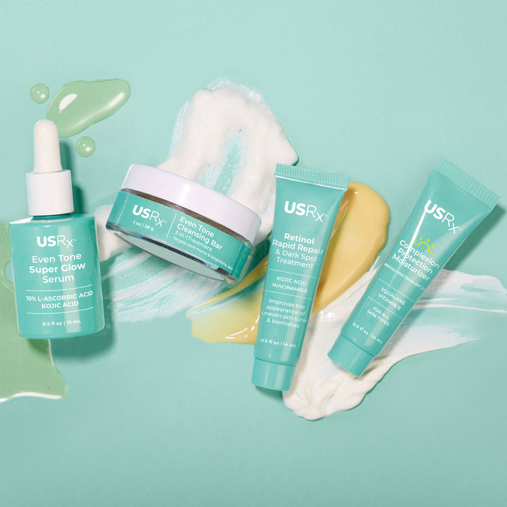 Assortment of bottles of Urban Skin RX Even Tone Super Glow Serum, Even Tone Cleansing Bar, Retinol Treatment, and Complexion Protection Moisturizer Sunscreen