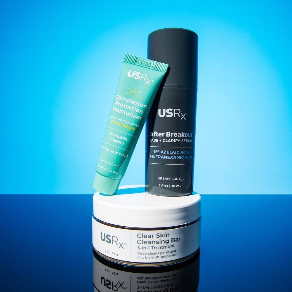 Assortment of USRx skincare products on a light blue background