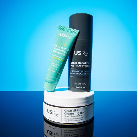 Assortment of USRx skincare products on a light blue background
