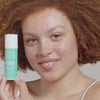 Woman applying USRX Complexion Protection Moisturizer Sunscreen with SPF 30 to her face