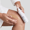 Woman applying Urban Skin RX Even Tone Smoothing Body Treatment on her leg