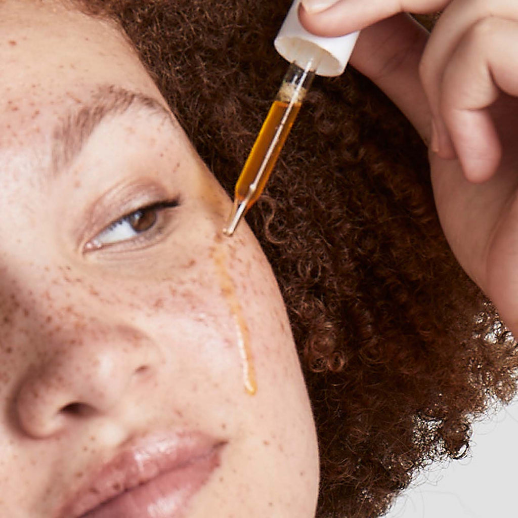 Woman applying Urban Skin RX Super C Brightening Serum product on her face