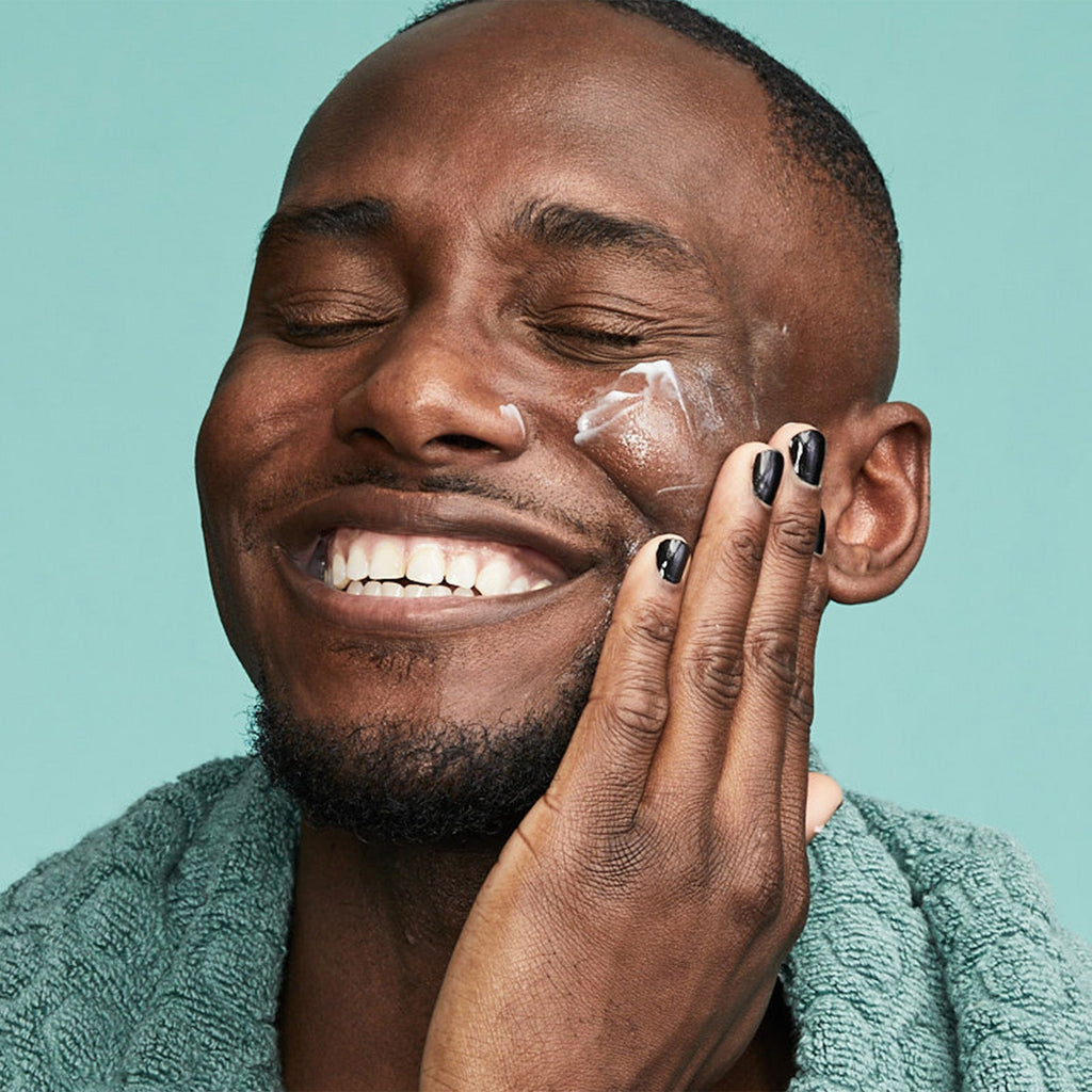 Man applying Urban Skin RX Even Tone Soothing Moisturizer to his face