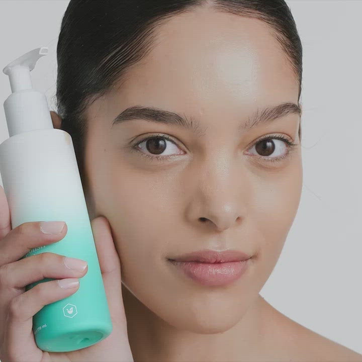 Woman applying USRx LacticGlow Cleanser to her face